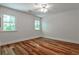 Bright, minimalist bedroom with two windows and hardwood flooring at 270 Hollyridge Way, Roswell, GA 30076