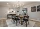 Well-lit dining room showcases hardwood floors, modern art, and a stylish chandelier above the wood table at 270 Hollyridge Way, Roswell, GA 30076