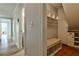 Hallway with built-in bench, storage, and cubbies, and wood floors at 270 Hollyridge Way, Roswell, GA 30076