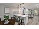 Open-concept kitchen with white cabinets, quartz countertops, stainless steel appliances, and hardwood flooring at 270 Hollyridge Way, Roswell, GA 30076