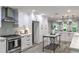 Spacious kitchen boasts white cabinets, stainless steel appliances, a center island, and an adjacent breakfast area at 270 Hollyridge Way, Roswell, GA 30076