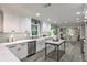 Beautiful kitchen featuring white cabinets, stainless steel appliances, a farmhouse sink, and hardwood floors at 270 Hollyridge Way, Roswell, GA 30076
