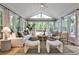 Sunlit living room with large windows, neutral decor, and comfortable seating, creating a relaxing atmosphere at 270 Hollyridge Way, Roswell, GA 30076