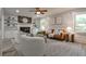 Bright living room featuring a fireplace, built-in shelving, modern furniture, and large windows at 270 Hollyridge Way, Roswell, GA 30076