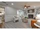 Cozy living room with a brick fireplace, built-in bookshelves, hardwood floors, and comfortable seating at 270 Hollyridge Way, Roswell, GA 30076