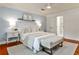A large bedroom with a ceiling fan, neutral decor, and a view to the en-suite bathroom at 270 Hollyridge Way, Roswell, GA 30076