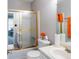 Bathroom featuring a tub with sliding glass doors and neutral tones at 8566 Jamestown Way, Jonesboro, GA 30238