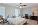 Bedroom featuring two windows and a ceiling fan, offering comfort and ample light at 8566 Jamestown Way, Jonesboro, GA 30238