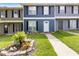 Charming townhome featuring a well-manicured lawn and colorful flowerbed enhancing its curb appeal at 8566 Jamestown Way, Jonesboro, GA 30238