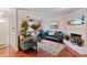 Inviting living room featuring a cozy fireplace, elegant furnishings, and warm hardwood flooring at 8566 Jamestown Way, Jonesboro, GA 30238