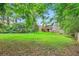 Large, grassy backyard offering ample space for recreation and gardening, surrounded by trees at 1134 Jefferson Ave, East Point, GA 30344