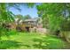 View of the house with a large green backyard, wooden fence, and deck stairs at 1134 Jefferson Ave, East Point, GA 30344