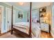 Bedroom with a four-poster bed, classic decor, and a bedside table with a lamp at 1134 Jefferson Ave, East Point, GA 30344