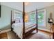 Charming bedroom with a four-poster bed, hardwood floors, and natural light from two windows at 1134 Jefferson Ave, East Point, GA 30344