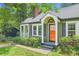 Charming home featuring a bright orange front door and well-kept landscaping at 1134 Jefferson Ave, East Point, GA 30344