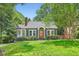 Charming bungalow featuring a brick chimney, inviting front porch, and lush lawn at 1134 Jefferson Ave, East Point, GA 30344