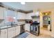 Well-lit kitchen featuring stainless steel appliances, granite countertops, and tile backsplash at 1134 Jefferson Ave, East Point, GA 30344