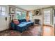 Inviting living room with a fireplace, hardwood floors, and a comfortable blue sectional at 1134 Jefferson Ave, East Point, GA 30344