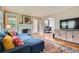 Cozy living room with a fireplace, hardwood floors, and comfortable blue sectional sofa at 1134 Jefferson Ave, East Point, GA 30344