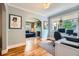 Comfortable home office with hardwood floors, leading into a living room with a fireplace at 1134 Jefferson Ave, East Point, GA 30344