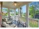 Charming screened porch featuring comfortable seating, ceiling fan and view of front yard at 1134 Jefferson Ave, East Point, GA 30344