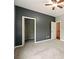 A large bedroom with neutral carpet features two closets and a ceiling fan at 119 Hardy Water Dr, Lawrenceville, GA 30045