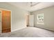 Bright, airy bedroom with neutral walls, ceiling fan, carpeting and walk in closet at 119 Hardy Water Dr, Lawrenceville, GA 30045