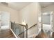 Upstairs hallway with wood floors and doors leading to bedrooms at 119 Hardy Water Dr, Lawrenceville, GA 30045