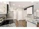Spacious kitchen with granite countertops, stainless appliances, white cabinets and hardwood floors at 119 Hardy Water Dr, Lawrenceville, GA 30045