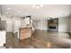Open living area with a kitchen island, hardwood floors, and a modern fireplace at 119 Hardy Water Dr, Lawrenceville, GA 30045
