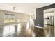Open-concept living room with wood floors, natural light and a view into the kitchen at 119 Hardy Water Dr, Lawrenceville, GA 30045