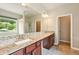 Bathroom featuring double sinks with granite countertops, large mirror, and natural light at 119 Hardy Water Dr, Lawrenceville, GA 30045