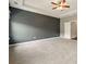 Large main bedroom with gray accent wall, tray ceiling, ceiling fan, and carpeted floors at 119 Hardy Water Dr, Lawrenceville, GA 30045