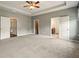 Large main bedroom with tray ceilings, carpeted floors and entry to bathroom and walk-in closet at 119 Hardy Water Dr, Lawrenceville, GA 30045