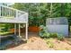 View of a backyard showing a deck, gray storage shed and wood fence at 2081 Township Dr, Woodstock, GA 30189
