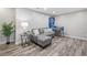 Finished basement area, complete with a sectional couch, pinball machine, and plank flooring at 2081 Township Dr, Woodstock, GA 30189