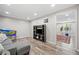 Basement living room area with a TV, pinball machine and adjacent room beyond an open doorway at 2081 Township Dr, Woodstock, GA 30189
