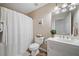 Bathroom features a white vanity, large mirror with lighting and a shower with white curtain at 2081 Township Dr, Woodstock, GA 30189