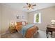 Bedroom featuring a full bed, window view of trees, desk, and rattan nightstand at 2081 Township Dr, Woodstock, GA 30189