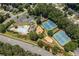Aerial view of the community amenities including pool, tennis courts, and sand volleyball court at 2081 Township Dr, Woodstock, GA 30189