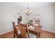 Elegant dining room featuring hardwood floors, chandelier, and table setting for four guests at 2081 Township Dr, Woodstock, GA 30189