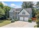 Beautifully landscaped home showcasing a well-manicured lawn, stone accents, and a two-car garage at 2081 Township Dr, Woodstock, GA 30189