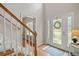 Inviting foyer featuring hardwood floors, decorative front door with sidelights, and access to staircase at 2081 Township Dr, Woodstock, GA 30189