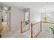 Second floor hallway with hardwood banister, view to the lower level and three doorways at 2081 Township Dr, Woodstock, GA 30189