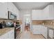 Bright kitchen featuring modern appliances, granite countertops, and ample cabinet space at 2081 Township Dr, Woodstock, GA 30189