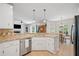 Contemporary kitchen with white cabinetry, tile backsplash, and granite countertops at 2081 Township Dr, Woodstock, GA 30189