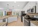 Spacious kitchen boasts an island, granite counters, and stainless steel appliances at 2081 Township Dr, Woodstock, GA 30189