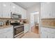 Well-lit kitchen with stainless steel appliances and granite countertops at 2081 Township Dr, Woodstock, GA 30189