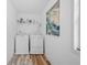Functional laundry room with a washer, dryer, and storage shelf space and natural light at 2081 Township Dr, Woodstock, GA 30189