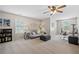 Spacious living room featuring a ceiling fan, large window, and versatile living and office space at 2081 Township Dr, Woodstock, GA 30189